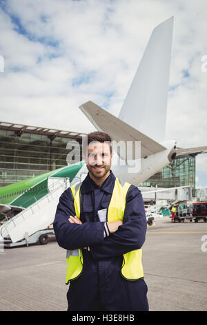 Portrait of airport ground crew standing on runway Stock Photo - Alamy