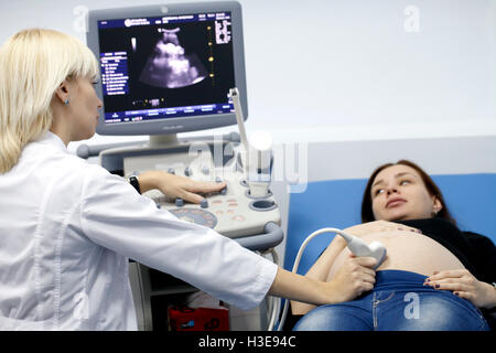 a Pregnant girl doing on ultrasound examination Stock Photo