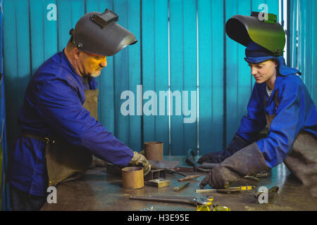 Male and female welders working together Stock Photo