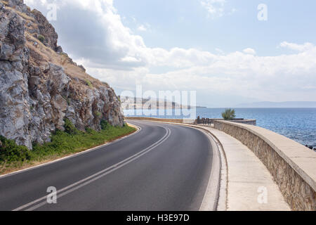 picturesque meandering asphalt road among sea and mountains Stock Photo
