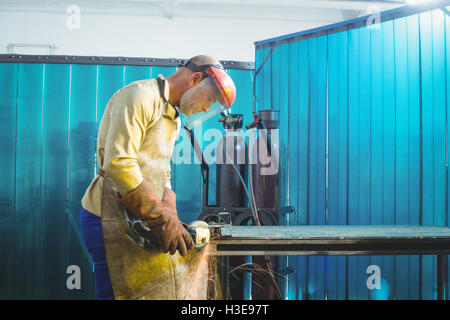 Male welder working on a piece of metal Stock Photo