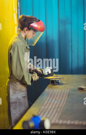 Female welder using circular saw Stock Photo