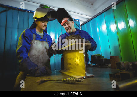 Male and female welders working together Stock Photo