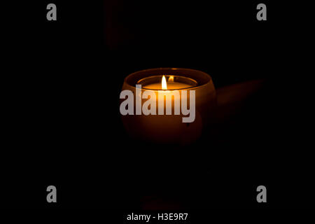 Single or Solitary Candle Against a Black Background Stock Photo