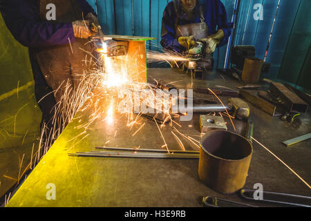 Male and female welders working together Stock Photo