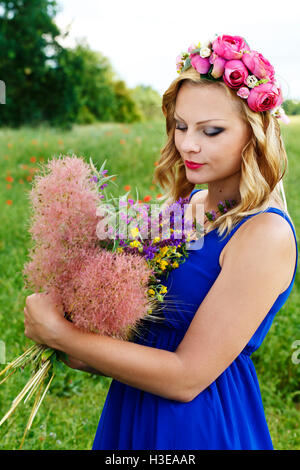 a beautiful young girl with flowers and beautiful nature around Stock Photo