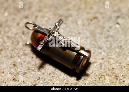 a Bullet and pectoral cross , abstract religion Stock Photo