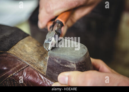 Close-up of shoemaker repairing a shoe Stock Photo