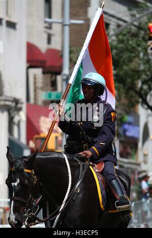 Mounted NYPD black female officer at the head of India Day Parade in Manhattan, New York. Stock Photo