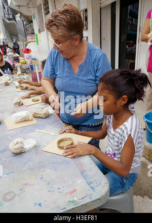 Mexican kids doing artwork during a local neighborhood festival in Acapulco, Mexico. Stock Photo