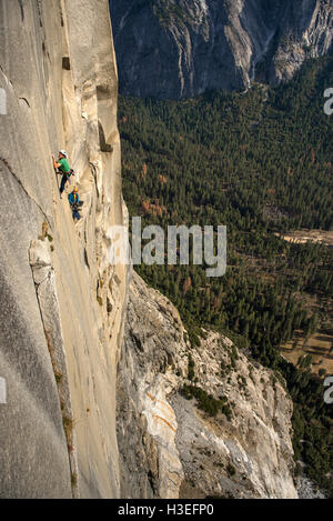 Two men free climbing a big wall route on El Capitan in Yosemite National Prk in the Sierra Nevada Mountains, California. Stock Photo