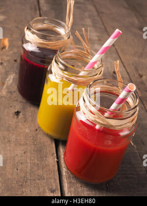 Three different healthy smoothie on a rustic wooden table Stock Photo