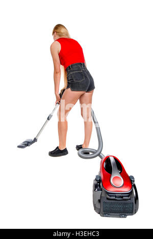 Rear view of a woman with a vacuum cleaner. She is busy cleaning. Rear view people collection. backside view of person. Isolated over white background. The girl in shorts with a vacuum cleaner cleans the floor. Stock Photo