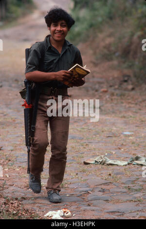 TENANCINGO,  EL SALVADOR, MARCH 1984: - Within the FPL Guerrilla's Zones of Control. A guerilla fighter with his book on outskirts of the town. Stock Photo