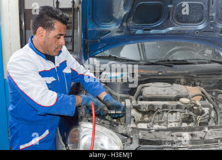 Car mechanic fixing an engine in his garage. copy space. Stock Photo
