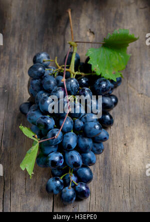 Bunch of red grapes on wooden table background Stock Photo