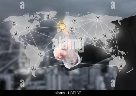 Businessman pressing modern social partnership network connection buttons on  virtual background. Partnership network connection Stock Photo