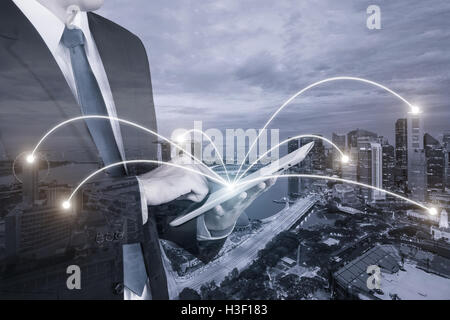 Double exposure of businessman using digital tablet pc with network connection of Singapore city. Network connection concept Stock Photo