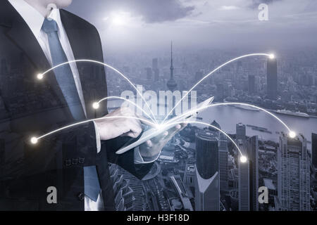Double exposure of businessman using digital tablet pc with network connection of Shanghai city. Network connection concept Stock Photo