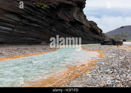 River with red shores and black lava walls on Kerlingarfjoll campground on Iceland. Stock Photo