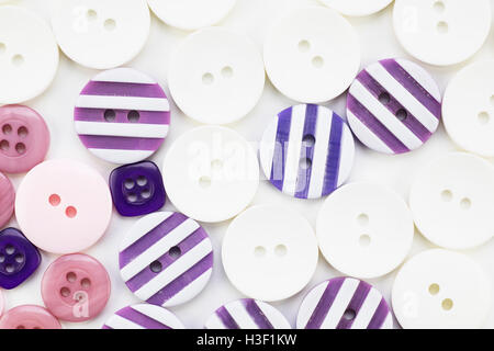 Colorful button texture with pink, purple and white buttons. Stock Photo