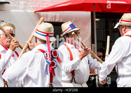 Broadstairs Folk Week. Traditional English Folk dancers, Hartley Morris side dancing and bashing poles together, Cotswold Style. Close up. Stock Photo