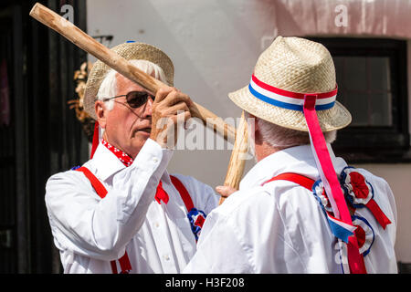 Broadstairs Folk Week. Traditional English Folk dancers, Hartley Morris side dancing and bashing poles together, Cotswold Style. Close up. Stock Photo