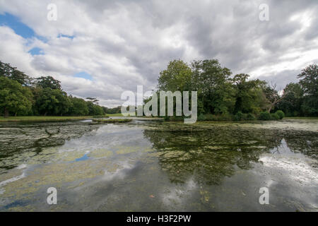 Landscape view of Painshill Park in Surrey, England with dramatic clouds and lake reflections Stock Photo