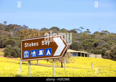 Road sign for Stokes Bay with logos for facilities, Kangaroo Island,South Australia Stock Photo