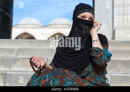 Smiling Arabic Woman Talking on Telephone Stock Photo