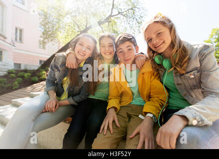 happy teenage students or friends hugging Stock Photo