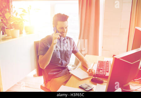 happy creative male worker calling on smarphone Stock Photo