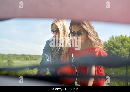 women with open hood of broken car at countryside Stock Photo