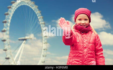 happy little girl waving hand over ferry wheel Stock Photo