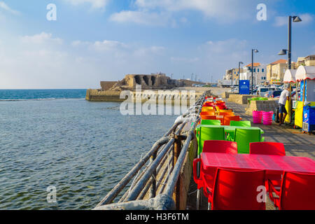 ACRE, ISRAEL - AUGUST 03, 2016: Scene of restaurants and other businesses, the walls, locals and tourists, in the old city of Ac Stock Photo