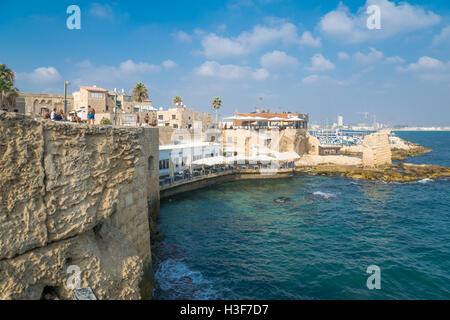 ACRE, ISRAEL - AUGUST 03, 2016: Scene of the sea walls, with local businesses, locals and tourists, in the old city of Acre, Isr Stock Photo