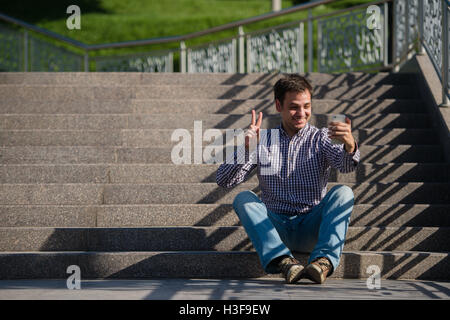 Handsome man video chatting on the phone Stock Photo