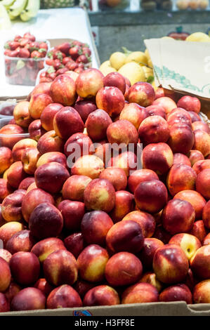 Close up of ripe fresh peaches on display for sale in farmers market. Stock Photo