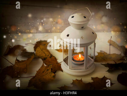 Autumn lantern with candle,lights and sparkle, dried leaves, festive magic lights Stock Photo