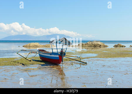 Fishing boat on the beach, Areia Branca, Dili, Timor Leste Stock Photo