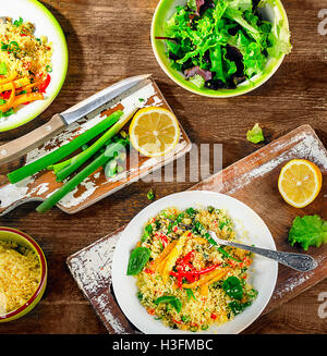Couscous with vegetables on a wooden table. Flat lay Stock Photo