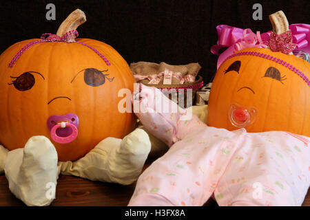 Two pumpkins dressed up as princess babies with pacifiers. Stock Photo