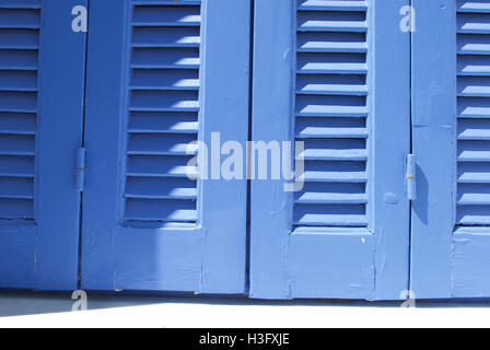 Blue, wooden window shutters in Samos, Greece. Stock Photo