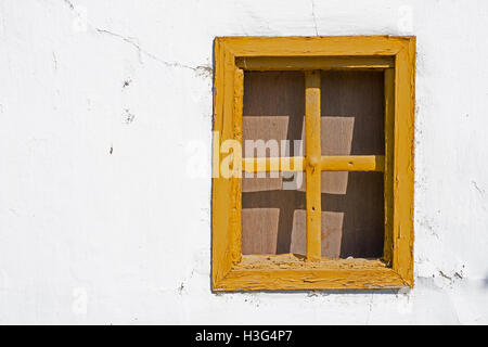 Old Yellow Window on Cracked Wall Stock Photo