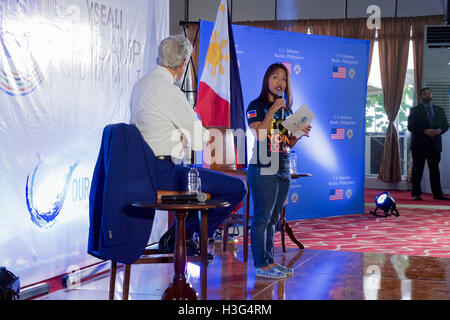 U.S. Secretary of State John Kerry listens to Anna Oposa, Executive Director of Save the Philippines Seas, as she delivers opening remarks at a Young Southeast Asian Leaders Initiative (YSEALI) Sea and Earth Advocate Camp on July 27, 2016, at the Sofitel Hotel in Manila, Philippines, before the Secretary and the group held a conversation about their mutual ocean preservation efforts. Stock Photo