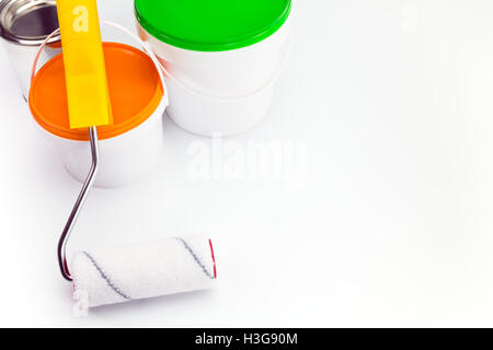 plastic cans with paint and paint roller on white background Stock Photo