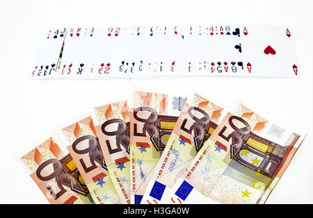 fifty euros and playing cards - gambling winnings concept Stock Photo