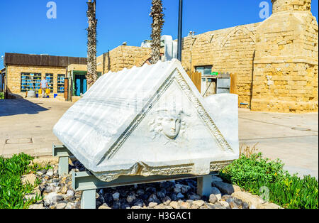 The ancient sarcofagus, decorated with relief of the mythic Medusa in Caesarea, Israel. Stock Photo