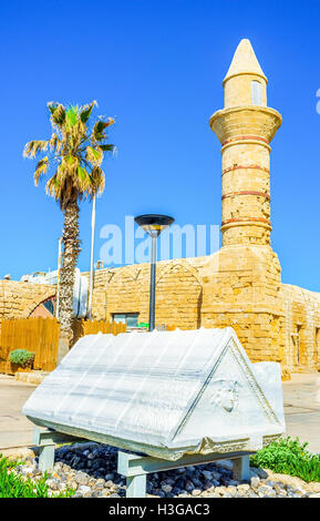 The scenic marble sarcofagus cover with the relief of Medusa, located next to the medieval mosque in Caesarea, Israel. Stock Photo