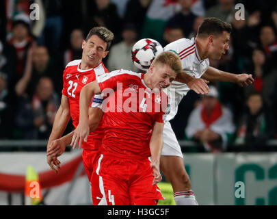 Budapest, Hungary. 07th Oct, 2016. BUDAPEST, HUNGARY - OCTOBER 7: Adam Szalai (R) of Hungary battles for the ball in the air with Nico Elvedi #4 of Switzerland and Fabian Schar #22 of Switzerland during the FIFA 2018 World Cup Qualifier match between Hungary and Switzerland at Groupama Arena on October 7, 2016 in Budapest, Hungary. Credit:  Laszlo Szirtesi/Alamy Live News Stock Photo